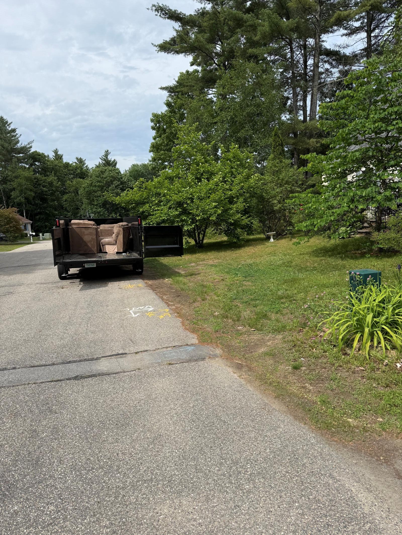 Recliners loaded in dump trailer after pickup
