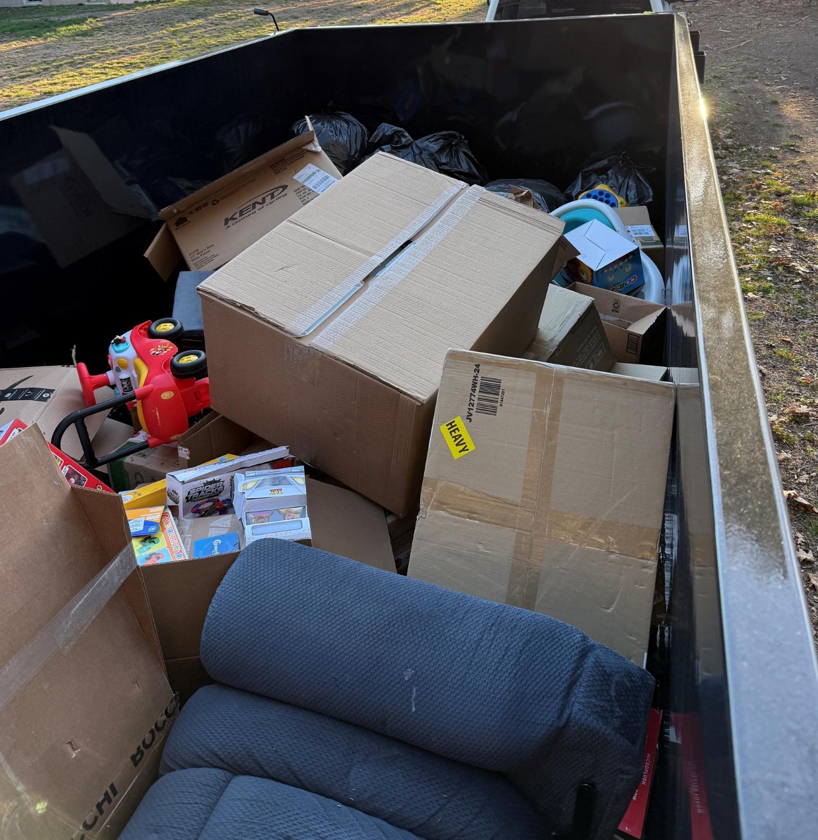 Loaded dump trailer with household cleanout items